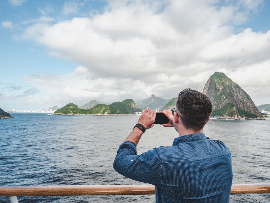 guy taking photo of Rio de Janeiro from cruise ship