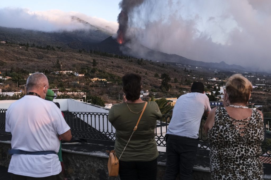 tourists watching volcano eruption in la palma