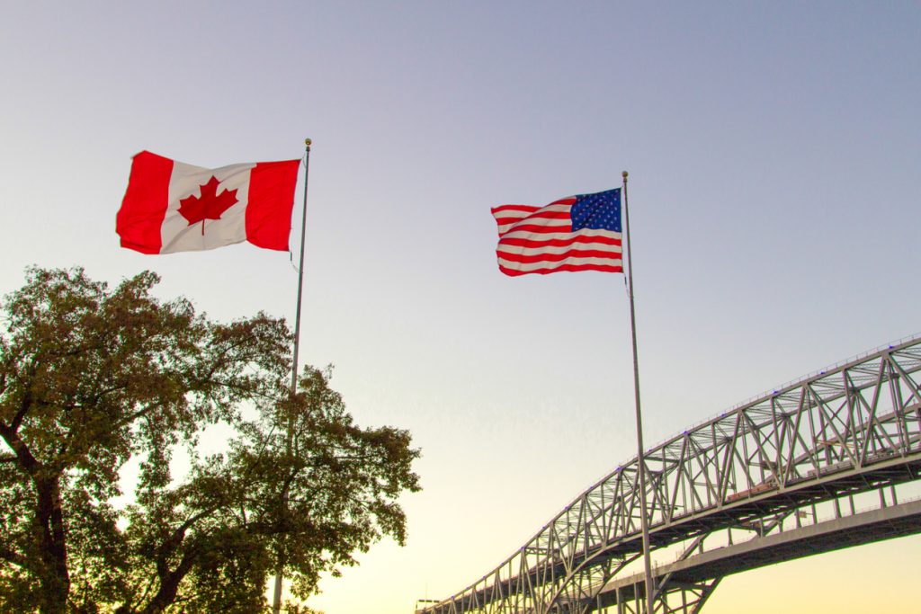 us canada flags at the border crossing