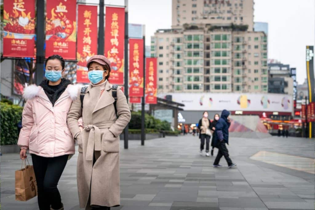 woman with masks in China walking during pandemic