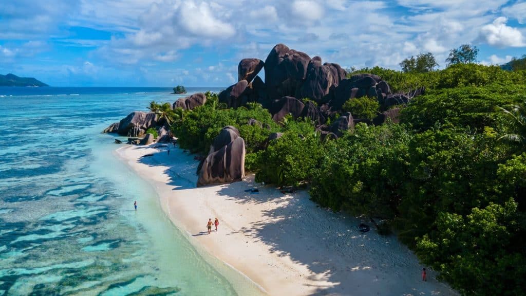 people waling on the beach in Seychelles