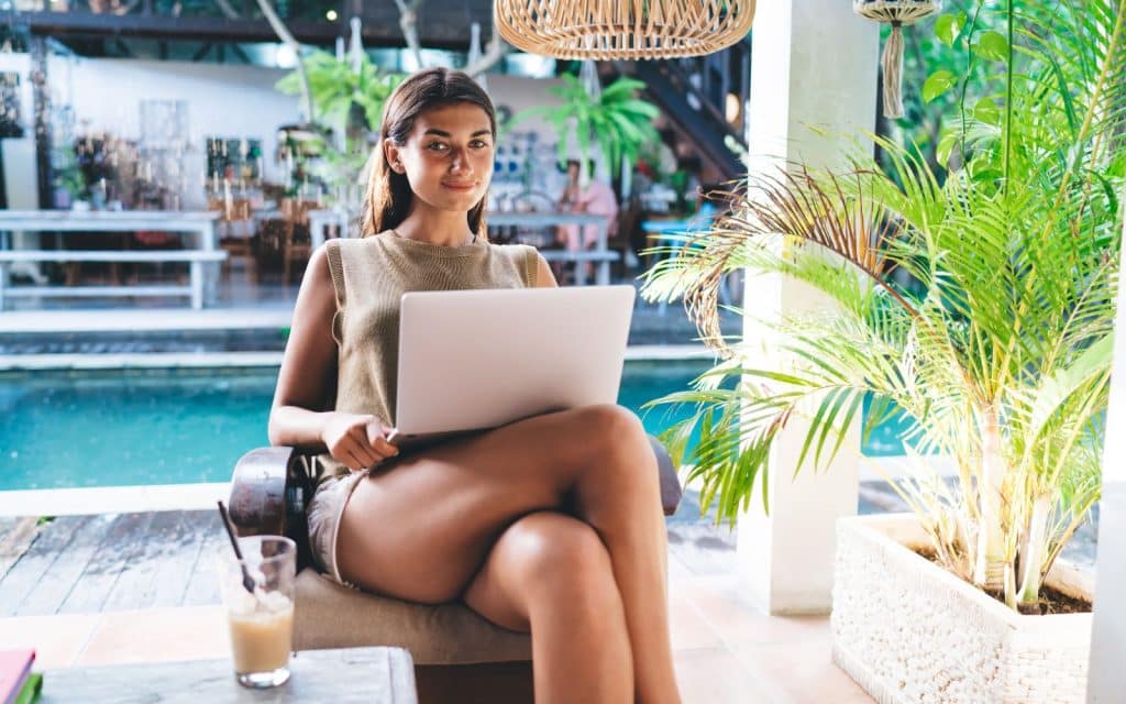 girl working remotely by the pool